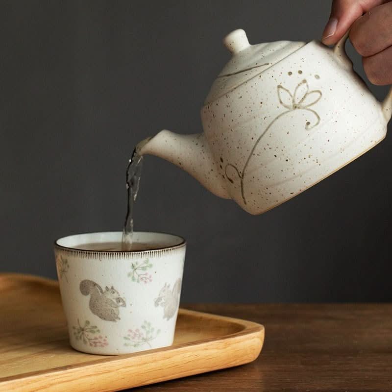 Japanese Mino-yaki ceramic cup with squirrels, beige, 6.76oz, pouring tea from teapot